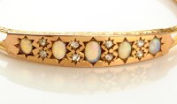 Lot 727 - An opal and diamond bangle, the central plaque...