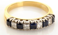 Lot 735 - A diamond and sapphire ring, the square cut...