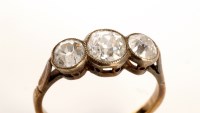 Lot 748 - A three stone diamond ring, each of the old...