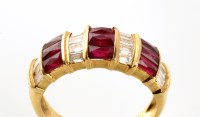 Lot 774 - A ruby and diamond ring, set with three panels...