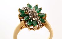 Lot 775 - A diamond and emerald asymmetric cluster ring,...