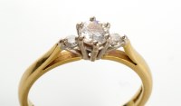 Lot 782 - A three stone diamond ring, the central...