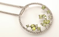 Lot 793 - A peridot and diamond pendant, the centre set...