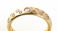 Lot 802 - A diamond half-hoop eternity ring, retailed by...