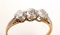 Lot 818 - A three stone diamond ring, the three slightly...