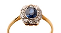 Lot 819 - A sapphire and diamond cluster ring, the...