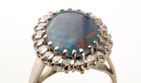 Lot 822 - An opal and diamond cluster ring, the central...