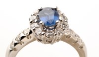 Lot 826 - A sapphire and diamond cluster ring, the...