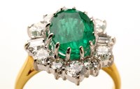 Lot 828 - An emerald and diamond cluster ring, the oval...