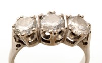 Lot 831 - A three stone diamond ring, the central stone...