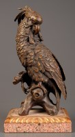 Lot 1039 - A patinated bronze parakeet, with glass eyes,...