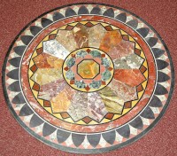 Lot 1055 - A specimen stone table top set with onyx,...