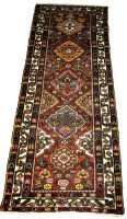 Lot 1114 - A west Persian Bakhtari runner, of stylized...