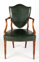 Lot 1168 - A shield-back open armchair, decorated with...