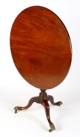 Lot 1170 - A late Georgian circular mahogany tip-up-top...