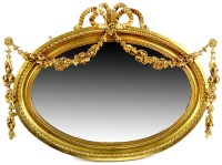 Lot 1189 - An oval gilt frame mirror with bevelled plate,...