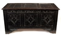 Lot 1242 - An ebonised oak coffer, the panelled lid above...