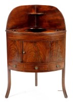 Lot 1252 - A George III mahogany corner washstand, with...