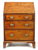 Lot 1259 - A George III mahogany bureau of small...