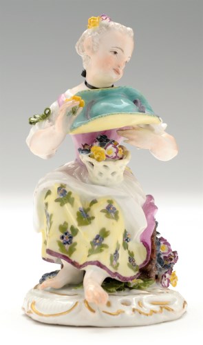 Lot 156 - Meissen figure of a flower girl, sitting on...