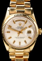 Lot 744 - Rolex, Oyster Perpetual Day/Date: an 18ct....