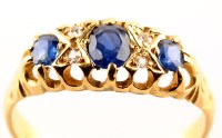 Lot 800 - A sapphire and diamond ring, the three...