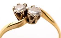 Lot 819 - A two stone diamond ring, each stone weighing...