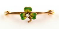 Lot 825 - A green enamel and diamond set shamrock...