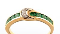 Lot 828 - An emerald and diamond ring, of buckle design,...