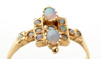 Lot 850 - An opal ring, set with oval and circular opal...