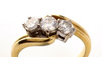 Lot 857 - A three stone diamond ring, the three...