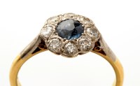 Lot 871 - A sapphire and diamond cluster ring, the...