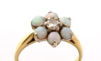 Lot 876 - An opal and diamond cluster ring, the central...