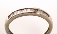 Lot 878 - A half-hoop diamond eternity ring, set with...