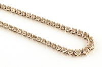 Lot 879 - A diamond set line necklace, each link with...