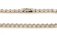 Lot 880 - A diamond line bracelet, each link set a...