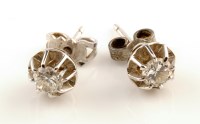 Lot 883 - A pair of diamond stud earrings, each weighing...