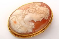 Lot 894 - A carved shell cameo brooch, the oval plaque...