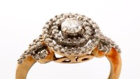 Lot 900 - A diamond target pattern ring, the central...