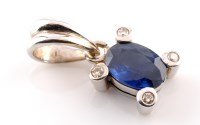 Lot 905 - A sapphire and diamond pendant, the oval facet...