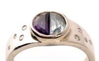 Lot 906 - An amethyst and aquamarine modern style ring,...