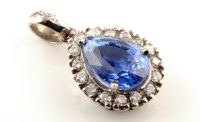 Lot 916 - A tanzanite and diamond cluster pendant, the...