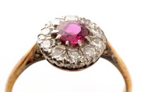 Lot 918 - A ruby and diamond cluster ring, the central...