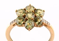 Lot 938 - A peridot cluster ring, set with seven...