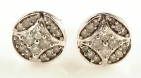 Lot 939 - A pair of diamond stud earrings, each set with...