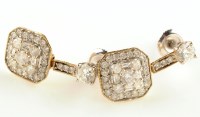 Lot 940 - A pair of diamond drop earrings, each with...