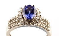 Lot 941 - A tanzanite and diamond cluster ring, the...