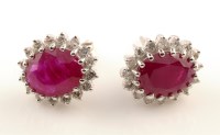 Lot 949 - A pair of ruby and diamond cluster earrings,...