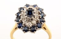 Lot 951 - A sapphire and diamond cluster ring, the...