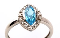 Lot 955 - A blue topaz and diamond cluster ring, the...